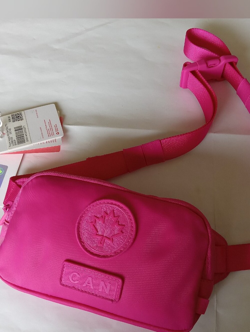 Lululemon Future Legacy Mini Belt Bag Bright Pink with Embossed Logo.